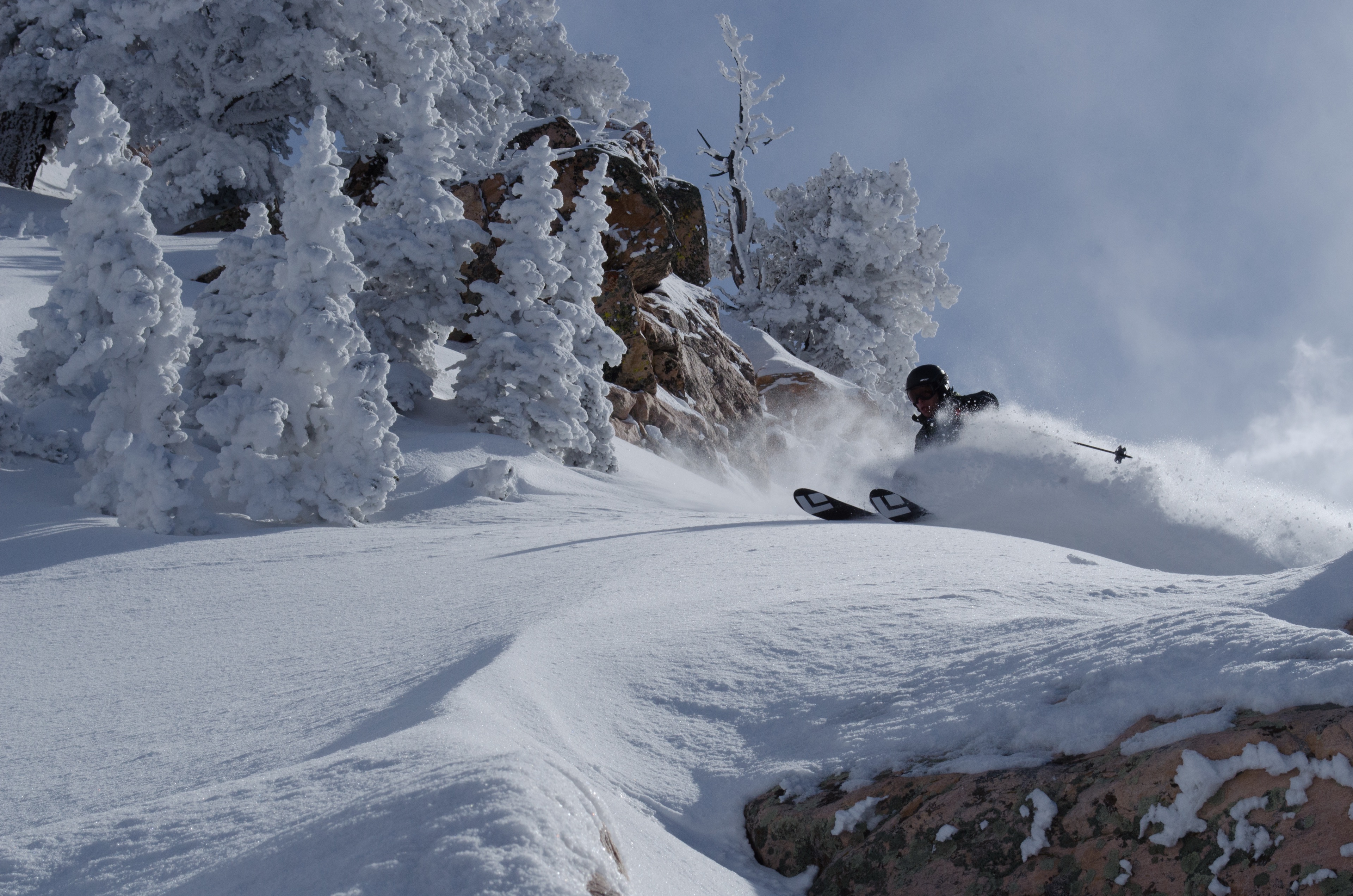 A skier cutting through deep powder in the Wasatch backcountry